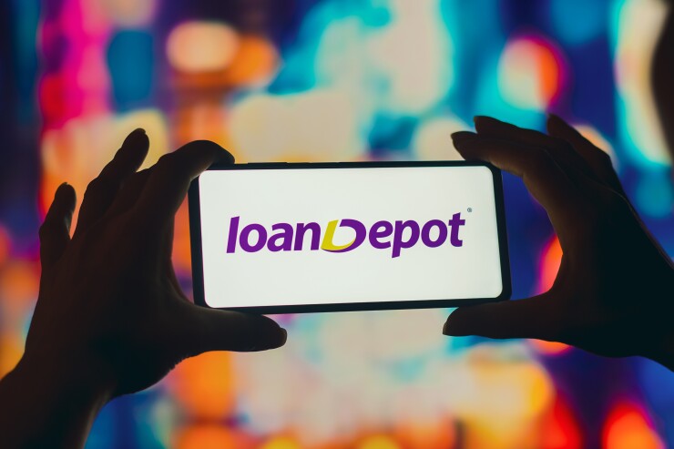 August 2, 2022, Brazil. In this photo illustration, a silhouetted woman holds a smartphone with the LoanDepot logo displayed on the screen.